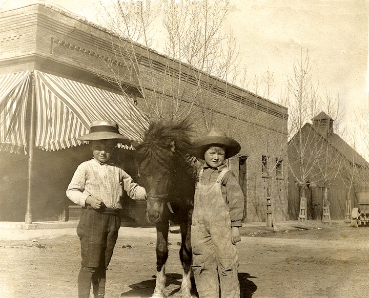 Floyd Morford and Marion Bowman with pony, Midge, about 1910 in front of the Purcell Building